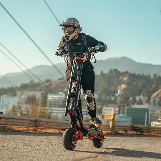 Person riding a scooter with mountainous landscape in the background